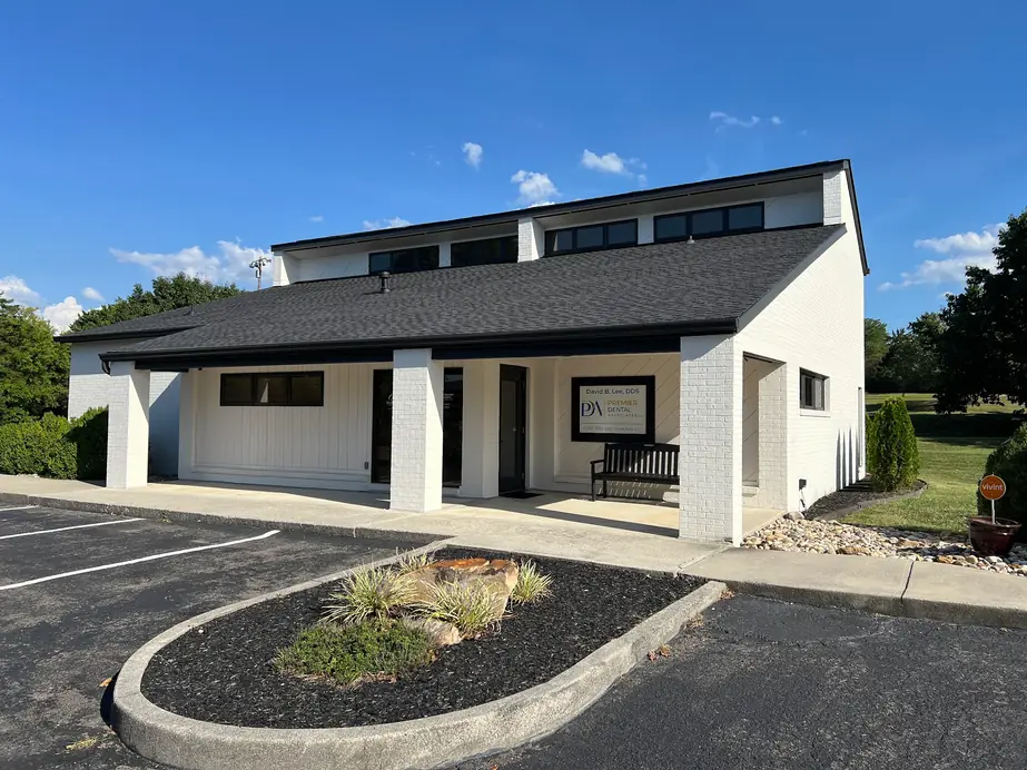 The white-brick Premier Dental Associates office at 201 Bus Terminal Rd, with its covered porch and landscaped island out front